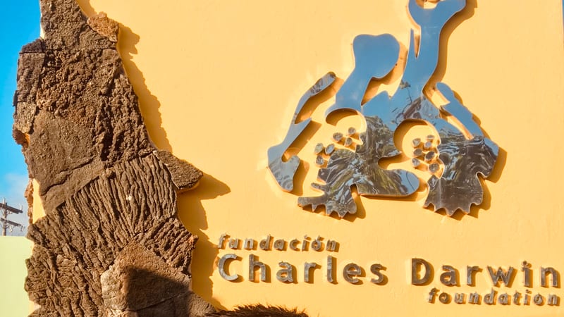The entrance sign, with the archipelago in relief beside it — Charles Darwin Research Station, Santa Cruz · January 2019