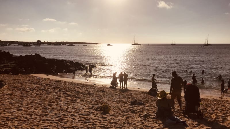 Late afternoon, when the town comes down to swim and the anchorage fills the horizon — Playa Mann, San Cristóbal · January 2019