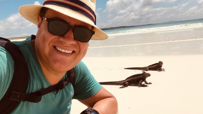 Marine iguanas on the sand, at the distance the park rules ask you to keep — Tortuga Bay, Santa Cruz · January 2019